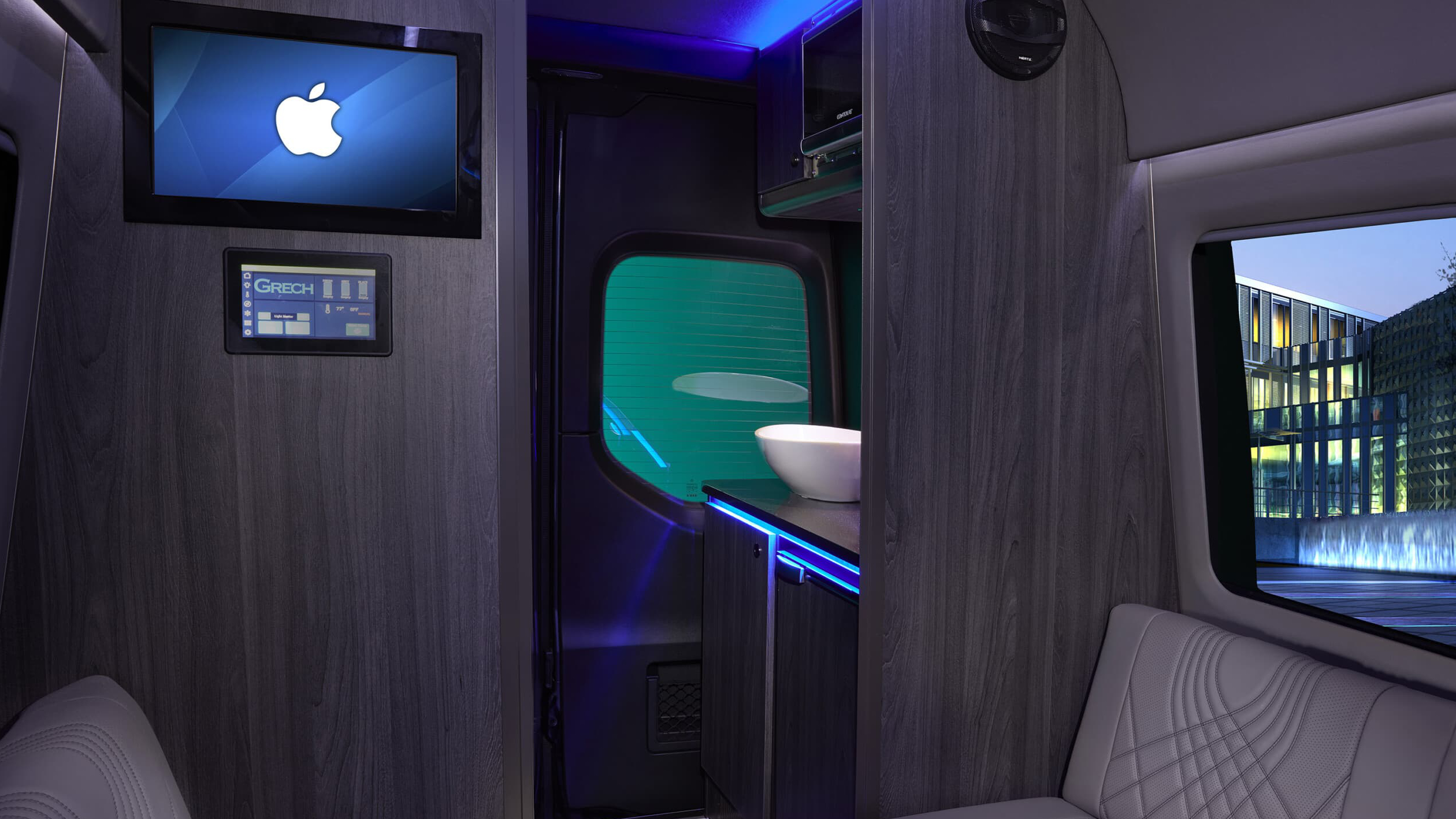 interior view of luxury car showing TV and sink