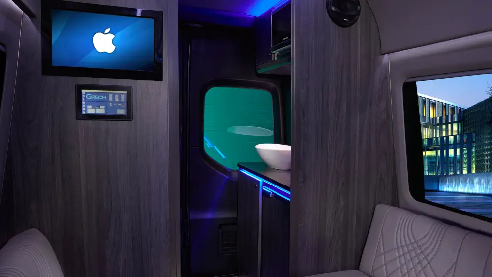 interior view of luxury car showing TV and sink