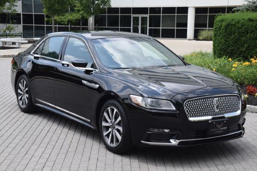 black sedan in front of building