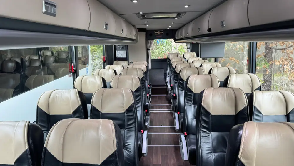 View from the back of a California Wine Tours motorcoach showing multiple rows of plush seats and wide windows