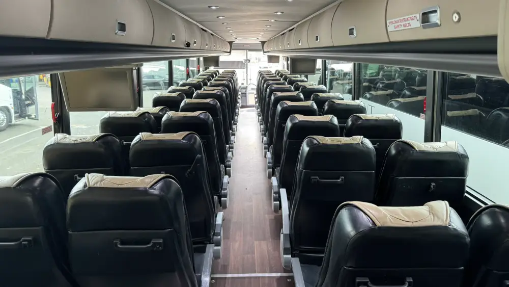 Sleek black leather seating inside a California Wine Tours shuttle bus designed for medium-sized group travel