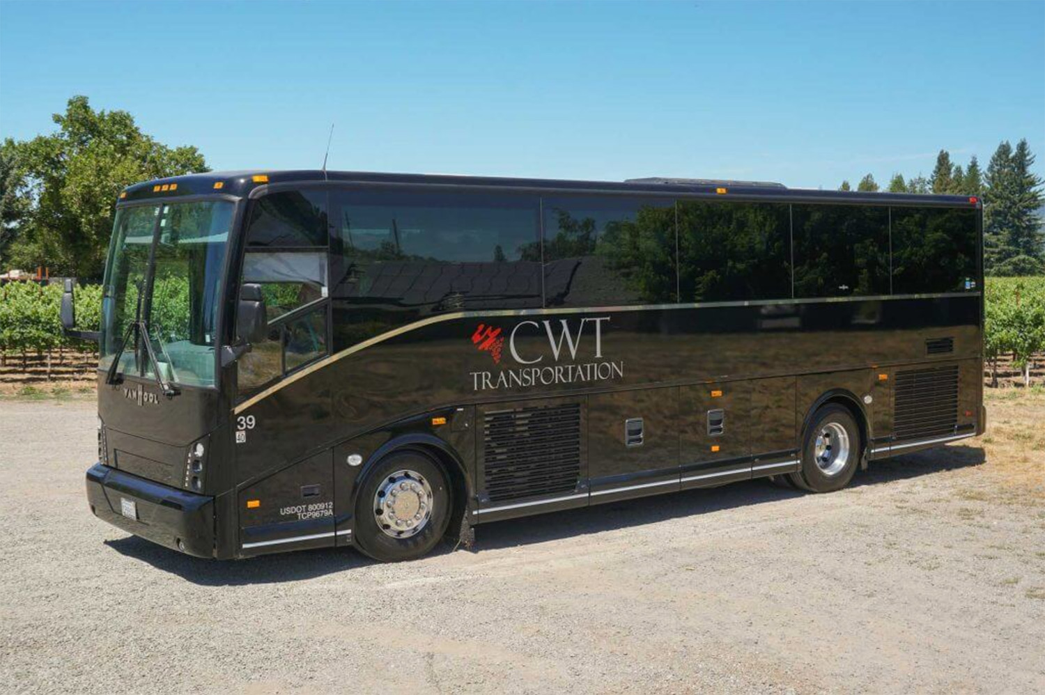 large motor coach in front of vineyard