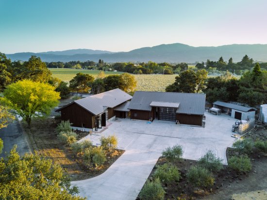 dakota-shy Overhead view of a house with a driveway, set against a backdrop of mountains, representing the Dakota Shy area.