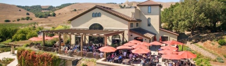 gloriaferrer A grand house with red umbrellas on the roof, symbolizing Gloria Ferrer.
