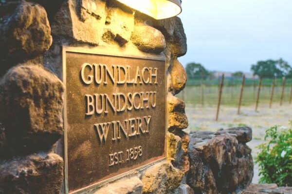 Sign for Gundlach Bundschu Winery, established in 1858, featuring the winery's name and logo.