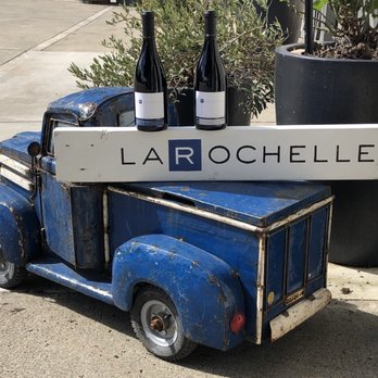 Larochelle wine shop exterior featuring a variety of wine bottles displayed in an inviting storefront.