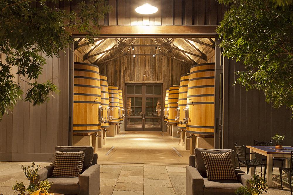 ramsgate A wine cellar in Ramsgate featuring chairs and tables arranged in front of wooden barrels.