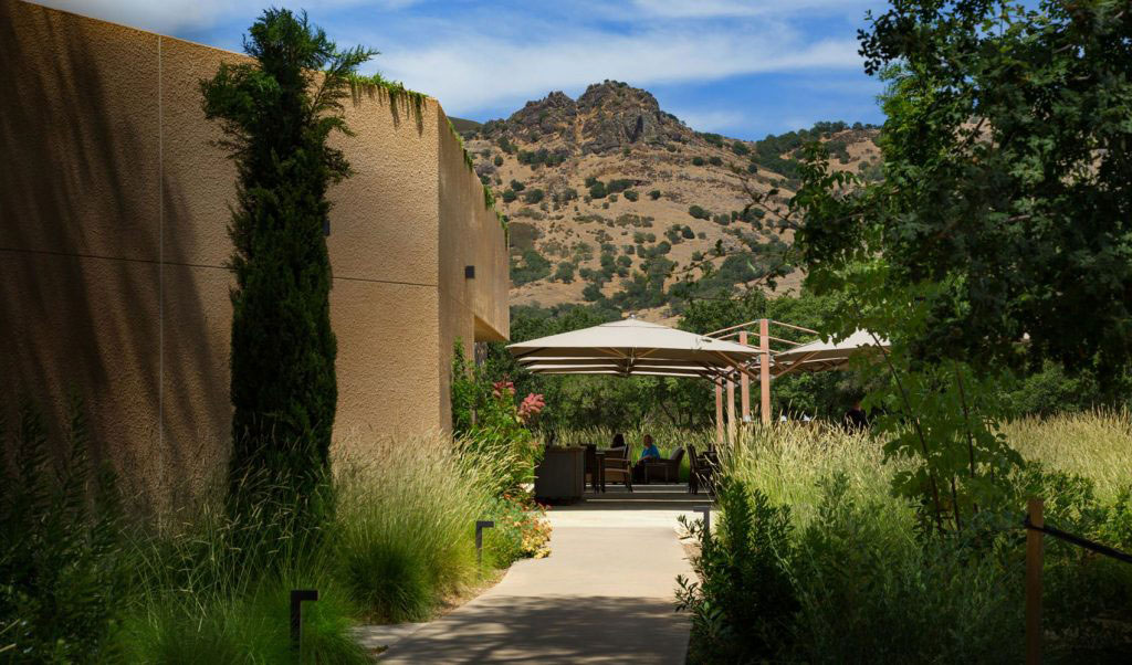 entrance to a winery and path to tables and chairs outside