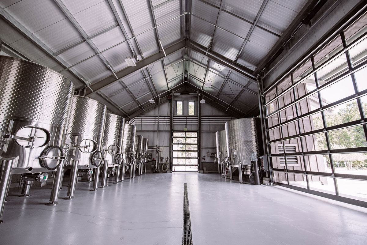 inside of a winery with steel tanks