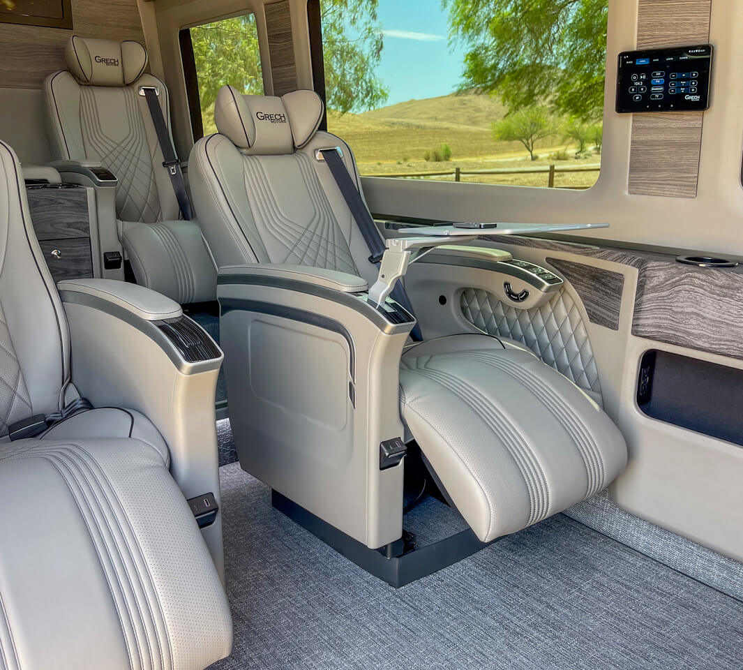 view of interior of luxury car showing leather seat recline