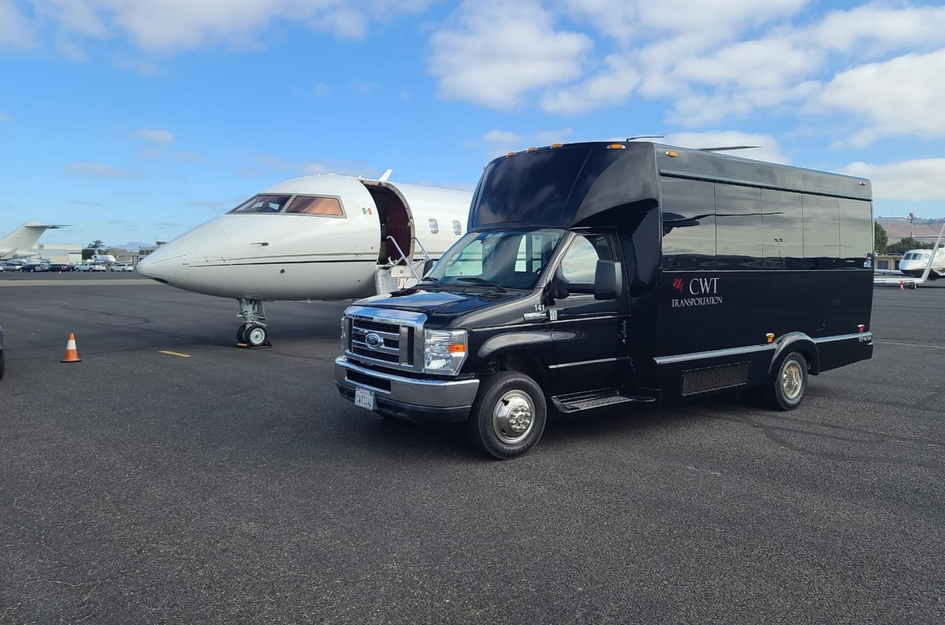 CWT Transportation mini coach beside private jet, offering premium corporate transportation in Napa for executive travelers.